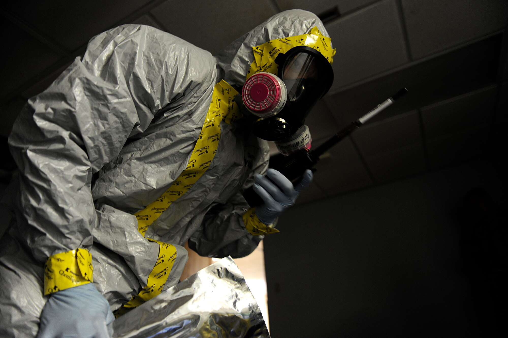 A U.S. Air Force Airman from the 18th Aerospace Medicine Squadron's Bioenvironmental Engineering Flight radios in his team's status during an emergency management exercise as part of Beverly High 12-5, a local operational readiness exercise on Kadena Air Base, Japan, Aug. 22, 2012. The EME tested Kadena Airmen's ability to respond, properly contain and decontaminate a possible anthrax threat on the base.  (U.S. Air Force photo/Senior Airman Maeson L. Elleman)