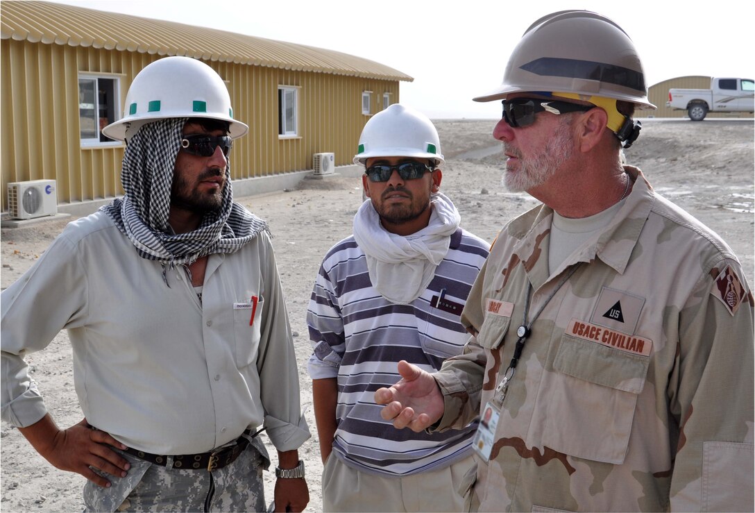 Our civilian professionals, engineers, scientists, and military personnel have the opportunity to serve their nation overseas. Here, a Charleston District employee collaborates with native Afghan at a construction site.