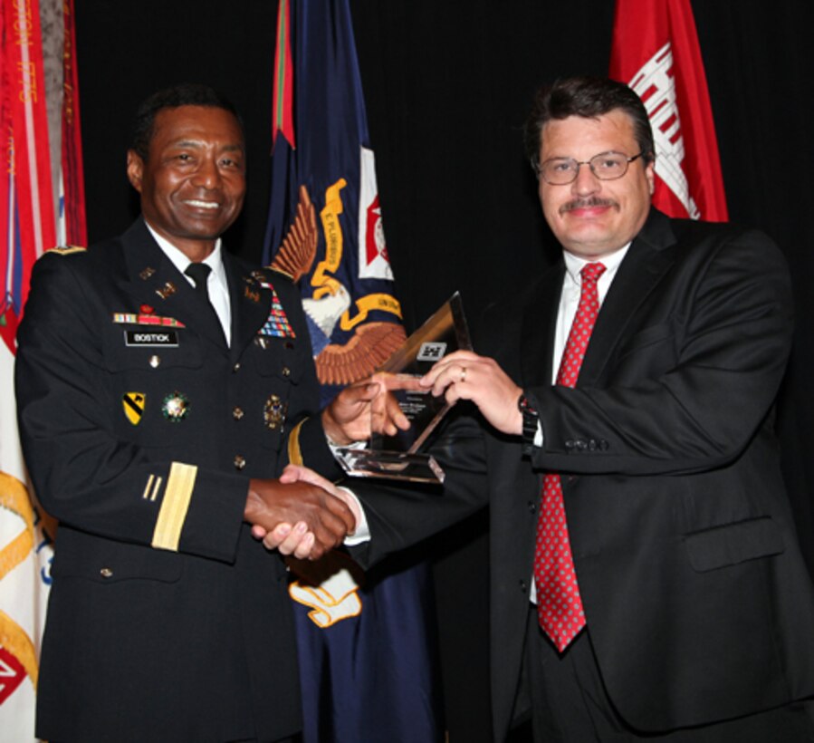 Lt. Gen. Thomas P. Bostick, left, commanding general of the U.S. Army Corps of Engineers, presents the National Contracting Organization Leadership Award to Mr. Brian Brobson, Tulsa District, Tulsa, Okla

