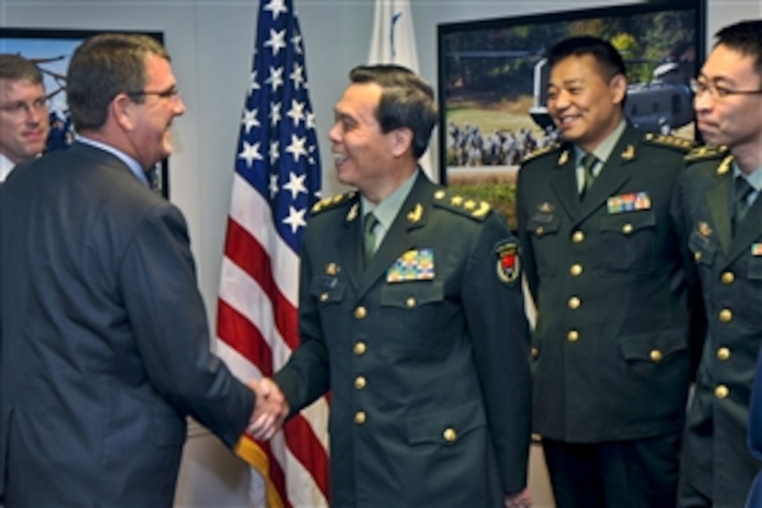 U.S. Deputy Defense Secretary Ashton B. Carter welcomes Cai Yingting, Chinese deputy chief of the General Staff of the People's Liberation Army, to a meeting at the Pentagon, Aug. 23, 2012. 