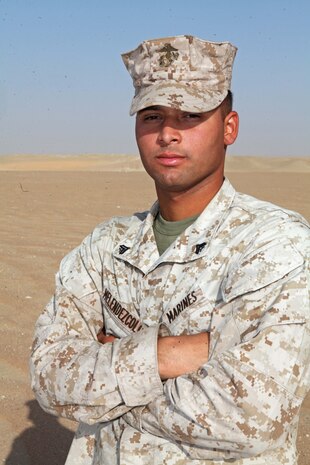Cpl. Diego Melendez, a embarkation specialist and Camden, N.J., native with Combat Logistics Battalion 24, 24th Marine Expeditionary Unit, poses for a photo, Aug. 12, 2012, on Udairi Range, Kuwait. The Marines are in Kuwait as part of a 24th MEU sustainment training package. The 24th MEU is deployed with the Iwo Jima Amphibious Ready Group as a U.S. Central Command theater reserve force providing support for maritime security operations and theater security cooperation efforts in the U.S. 5th Fleet area of responsibility.