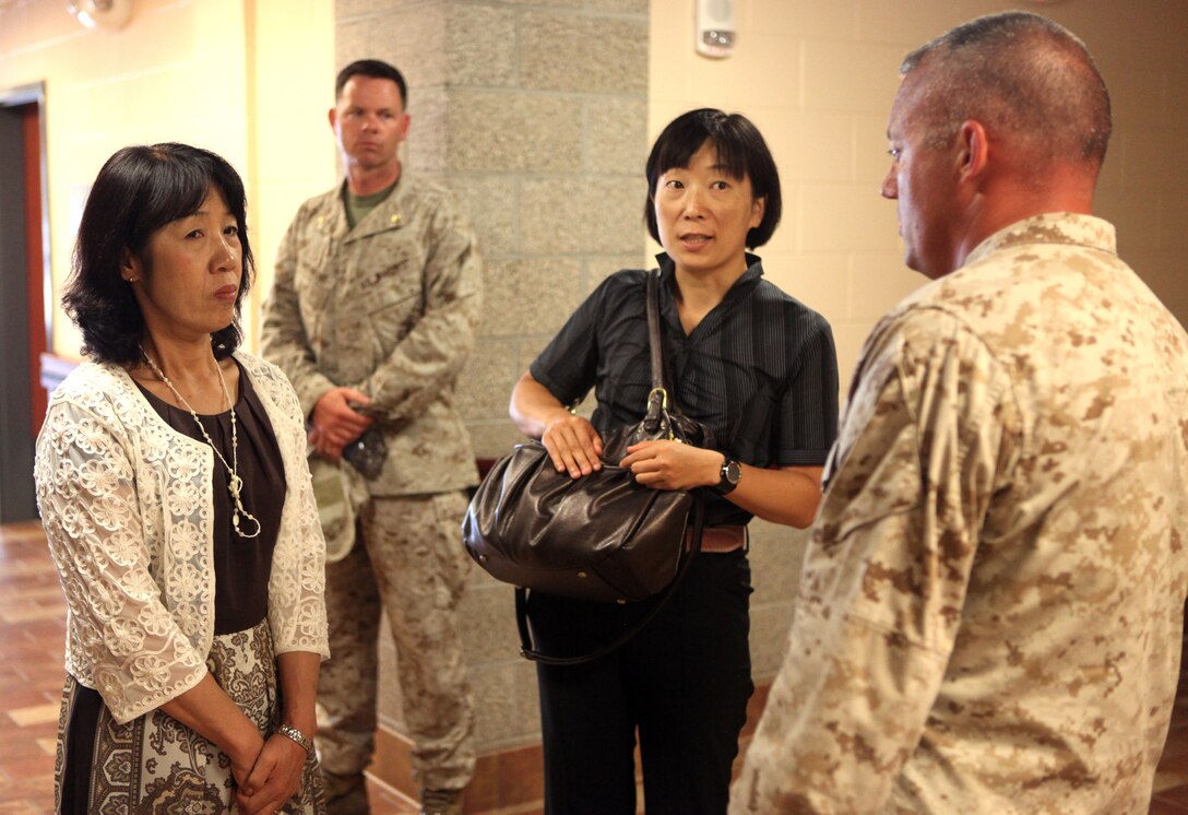 Toshiko Iwasaki (left), wife of the Chief of Staff for Japan’s Self-Defense Forces Gen. Shigeru Iwasaki, and Japanese Maj. Junko Uto, Iwasaki’s translator, speak with Lt. Col. Nicholas Davis, commanding officer of Wounded Warrior Battalion- East, during a tour of the wounded warrior barracks aboard Marine Corps Base Camp Lejeune Aug. 21. Davis showed Iwasaki the barracks where Marines in the battalion reside and explained some of the building’s features for injured Marines.