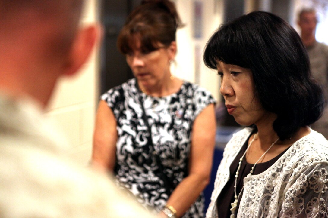 Toshiko Iwasaki, wife of the Chief of Staff for Japan’s Self-Defense Forces Gen. Shigeru Iwasaki, listens to an explanation of the amenities offered at Wounded Warrior Battalion – East’s barracks given by Lt. Col. Nicholas Davis, commanding officer of Wounded Warrior Battalion- East, during a tour of the barracks aboard Marine Corps Base Camp Lejeune Aug. 21. Davis showed Iwasaki the barracks where Marines in the battalion reside and explained some of the building’s features for injured Marines.