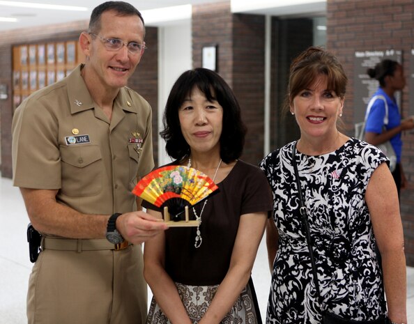 Navy Capt. David Lane (left), commanding officer of Naval Hospital Camp Lejeune, Toshiko Iwasaki (center), wife of the Chief of Staff for Japan’s Self-Defense Forces Gen. Shigeru Iwasaki, and Cindy Fox, wife of Maj. Gen. Raymond Fox, commanding general of II Marine Expeditionary Force, pose for a picture with a gift Iwasaki presented to Lane aboard Marine Corps Base Camp Lejeune Aug. 21. Lane showed Iwasaki around the hospital during her visit to NHCL.