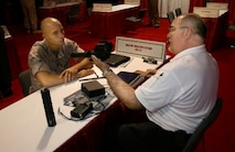 IWS demonstrating equipment to a Marine.