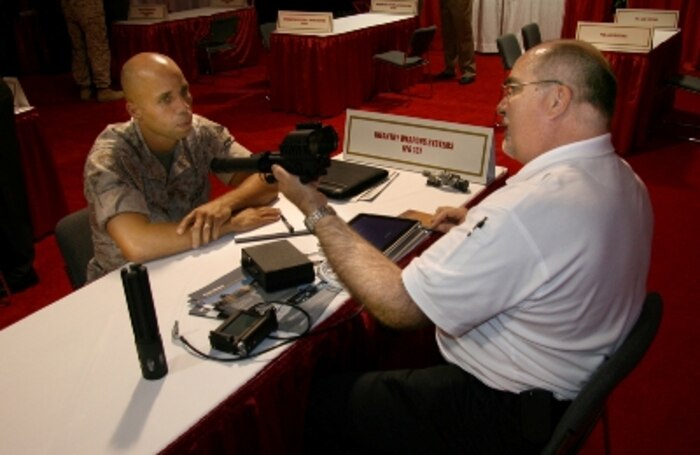 IWS demonstrating equipment to a Marine.
