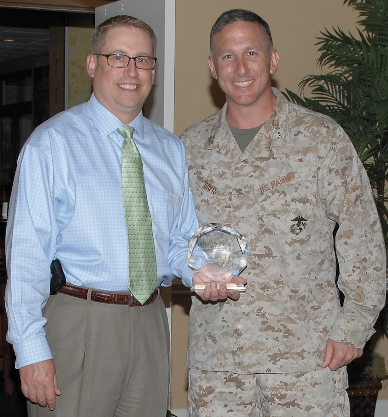 Craig Pruett, left, Food and Hospitality director, Marine Corps Community Services, receives the Irving Rubenstein Memorial Award from Col. Don Davis, commanding officer, MCLB Albany, during a ceremony, July 24.