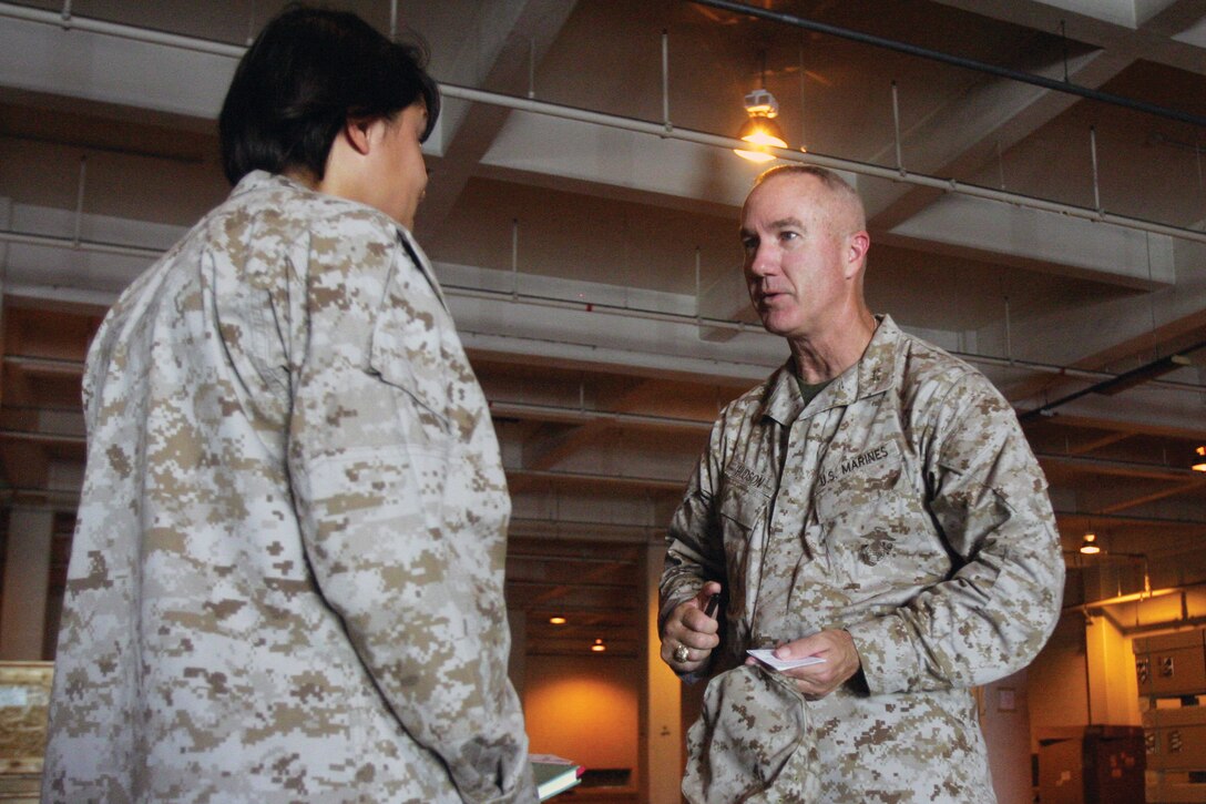 Maj. Gen. Charles L. Hudson speaks with 1st Lt. Heather R. Waldorf during a visit to Camp Kinser Aug. 21. Hudson is the commanding general of Marine Corps Logistics Command. Waldorf is a ground supply officer with 3rd Supply Battalion, Combat Logistics Regiment 35, 3rd Marine Logistics Group, III Marine Expeditionary Force.