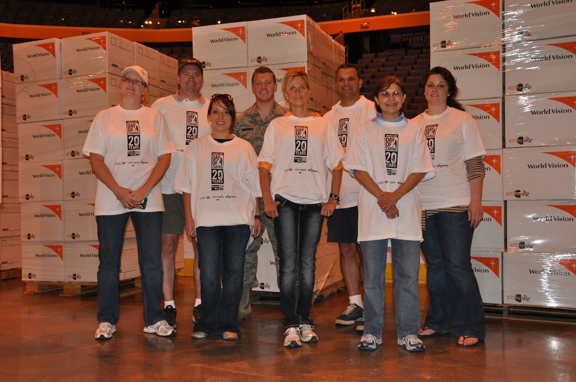 BUFFALO, N.Y. - Several volunteers from the 914th and 107th Airlift Wings volunteered their time to help fill backpacks with donated school supplies at First Niagara Arena, August 15, 2012.  As part of the 20th annual United Way Day of Caring, over one hundred volunteers gathered in the arena to fill 4,000 backpacks which will be given to needy local area school children. Pictured left to right are:  Maria Kendzierski, Capt. (Chaplain) James Bastian, Senior Airman Brittany LaFratta, Senior Airman Jackson Zimmerman, Valerie Mrzyglod, Tech. Sgt. Michael Melson, Tech. Sgt. Linda Stroka, Senior Airman Christina Kirk.  (U.S. Air Force photo by Master Sgt. Kevin Nichols)