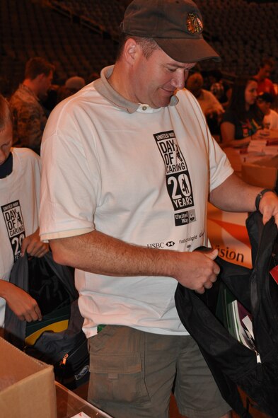 BUFFALO, N.Y. - Capt. James Bastian, 914th Airlift Wing, fills a backpack with donated school supplies at First Niagara Arena August 15.  Several volunteers from the 914th and 107th Airlift Wings volunteered their time to help in the 20th annual United Way Day of Caring.  As just one part of the overall Day of Caring, over 100 volunteers gathered in the arena to fill 4,000 backpacks which will be given to needy local area school children. (U.S. Air Force photo by Master Sgt. Kevin Nichols)