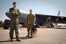 United States Air Force B-52 pilot, Major Chris Morris, stands in front of a B-52 with RAAF military working dog handler, Corporal Chris Bird and military working dog Dakota.  The Royal Australian Air Force is pleased to welcome a United States Air Force (USAF) B-52 and KC-135 from Andersen Air Force Base, Guam, to RAAF Base Darwin.  The USAF crew will conduct routine training in RAAF Base Darwin.  On departure from Darwin the B-52 will fly via Delamere Air Weapons Range to simulate ordnance drops with RAAF and practice aerial refueling operations.  This demonstrates Australia's commitment to increased cooperation with the United States.  Both nations share an intent for increased U.S. Air Force training with the RAAF, however decisions on future rotations including timings are still under discussion.  This is the first time a B-52 has landed at RAAF Darwin and since the United States and Australia announced enhanced aircraft cooperation as one of the two force postures initiatives, in November 2011.  (Courtesy photo)