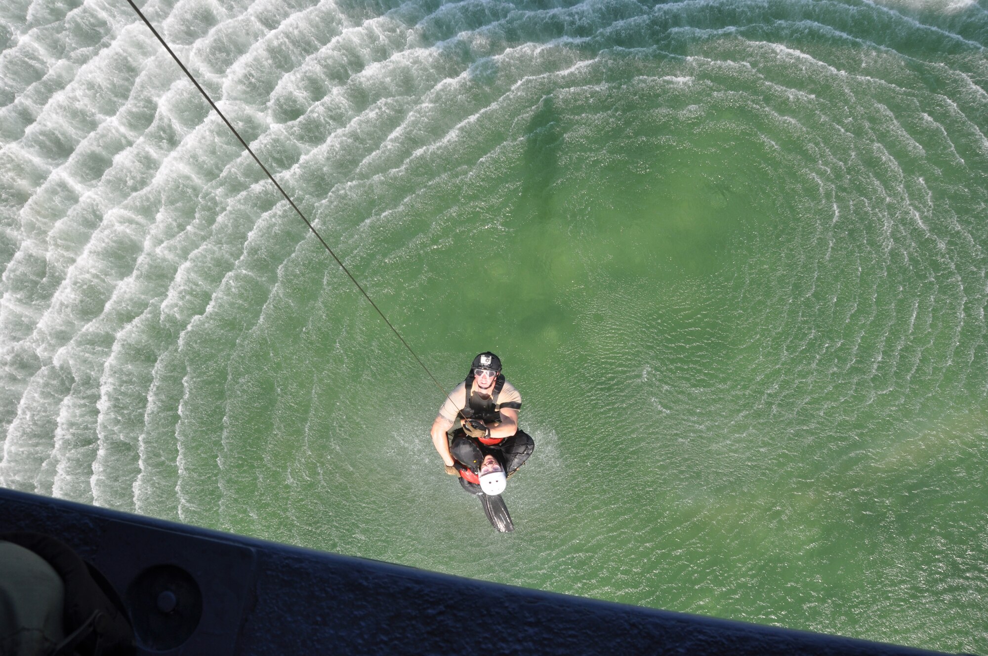 A pilot from the 457th Fighter Squadron is hoisted up to an HH-60G Pave Hawk helicopter during water-survival training at Naval Air Station Key West, Fla.,  Monday, Aug. 20. The exercise was conducted specifically for squadron pilots as part of readiness training. The 920th Rescue Wing from Patrick Air Force Base, Fla. provided HH-60G Pave Hawk helicopters, their crew, and pararescuemen to assist with the exercise. (U.S. Air Force photo/Senior Airman Melissa Harvey)