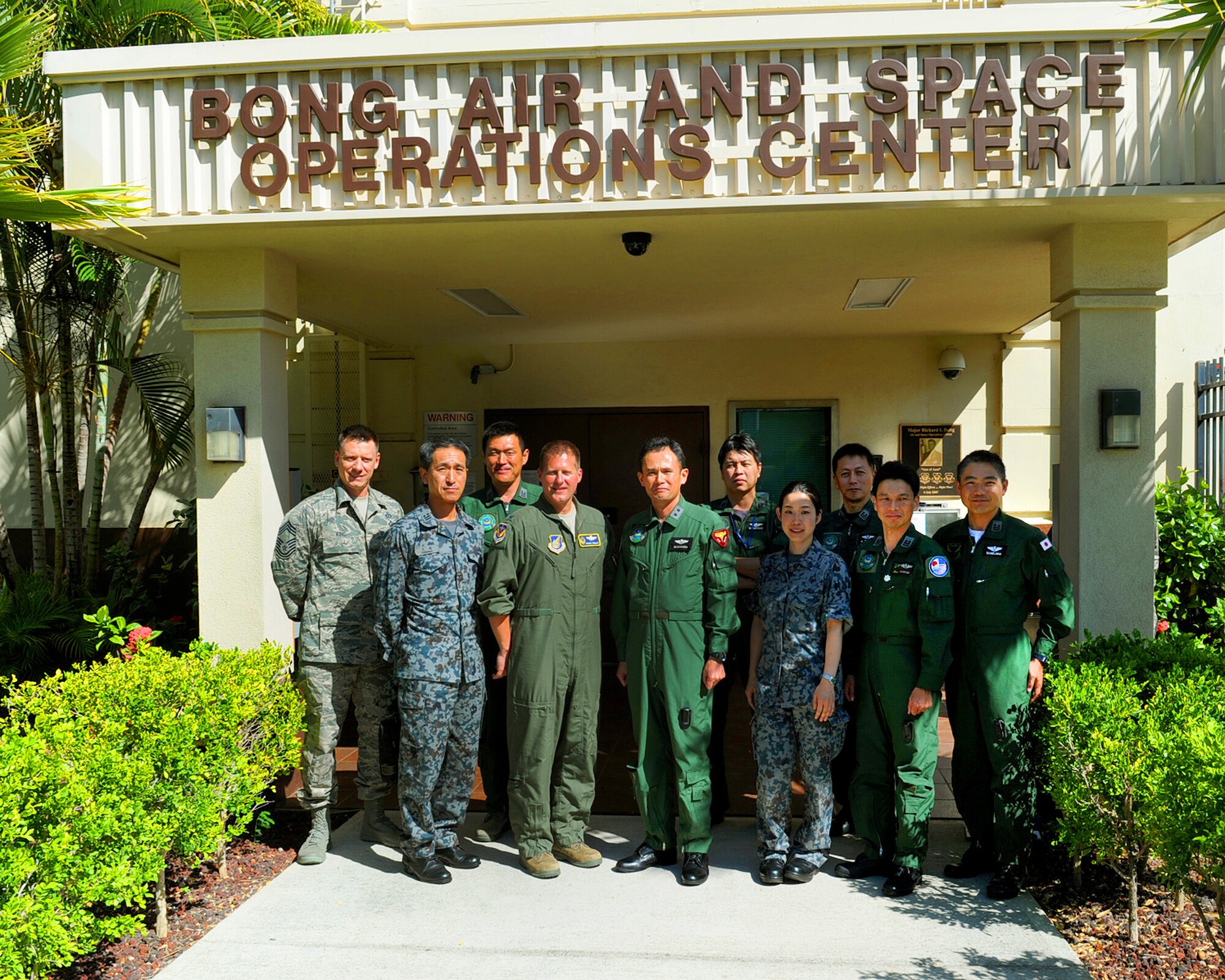 Col. Michael P. Winkler, 613th Air and Space Operations Center commander, and Maj. Gen. Misashi Yamada, Director of Defense Plans and Operations Directorate, Air Defense Command, Japan Air Self-Defense Force, and members of both staffs pose for a group photo in front of the 613th AOC, at Joint Base Pearl Harbor-Hickam Hawaii, Aug. 22, 2012.  Yamada visited with Winkler to discuss the 13th Air Force inactivation scheduled for Sept. 28, 2012, and the two explored new ways to continue efforts to enhance interactions between the 613th Air and Space Operations Center and the Japanese AOC. (U.S. Air Force photo/Tech. Sgt. Jerome S. Tayborn)