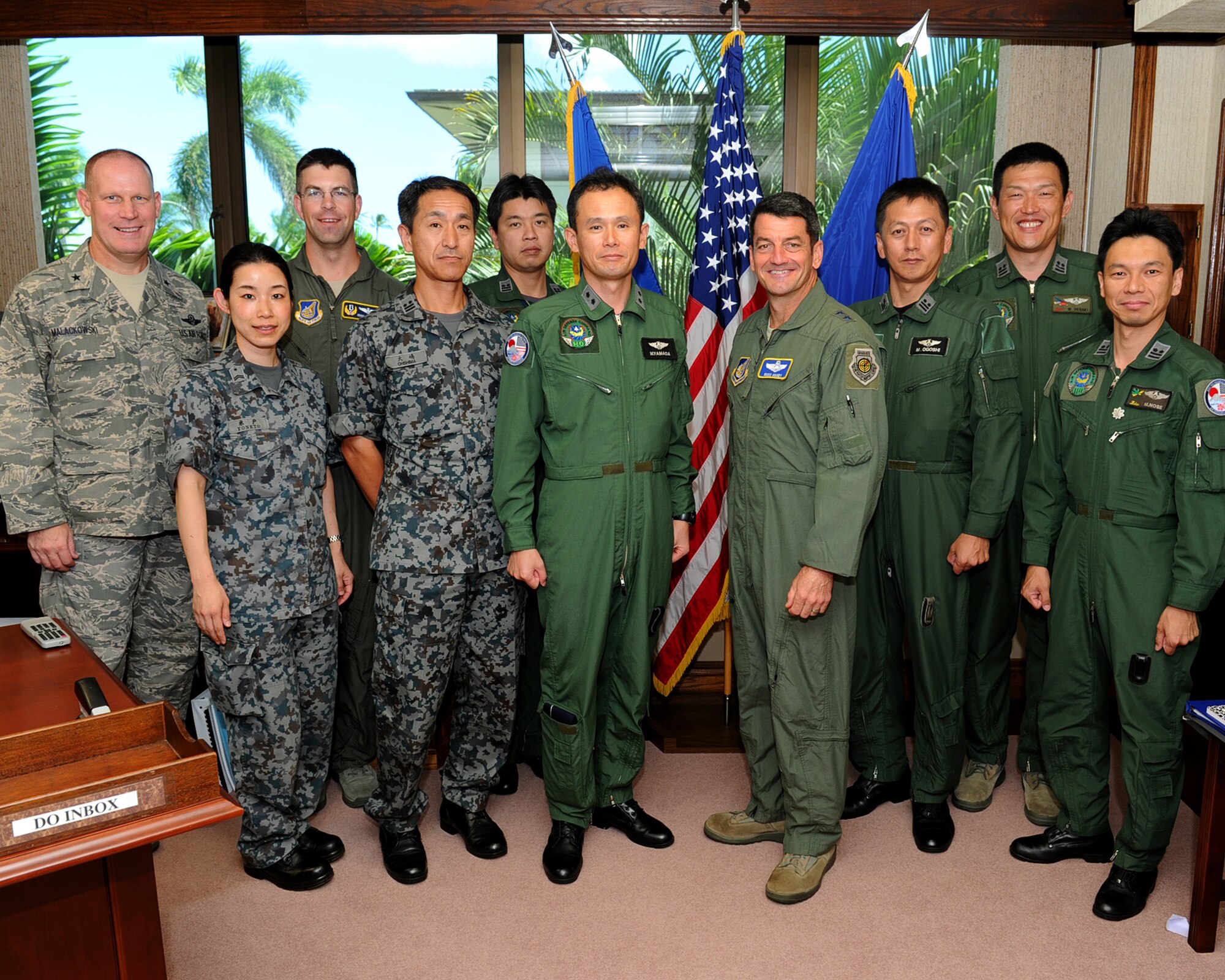 Maj. Gen. Misashi Yamada, Director of Defense Plans and Operations Directorate, Air Defense Command, Japan Air Self-Defense Force, and Maj. Gen. Russell J. Handy, Pacific Air Forces Director of Operations, Plans, Requirements and Programs, pose for a group photo with multiple JASDF and PACAF staff members at the PACAF headquarters building, Joint Base Pearl Harbor-Hickam, Hawaii, Aug. 22, 2012. Yamada visited with Handy to discuss the 13th Air Force inactivation scheduled for Sept. 28, 2012, and the two explored new ways to continue efforts to enhance interactions between the 613th Air and Space Operations Center and the Japanese AOC. (U.S. Air Force photo/Tech. Sgt. Jerome S. Tayborn)