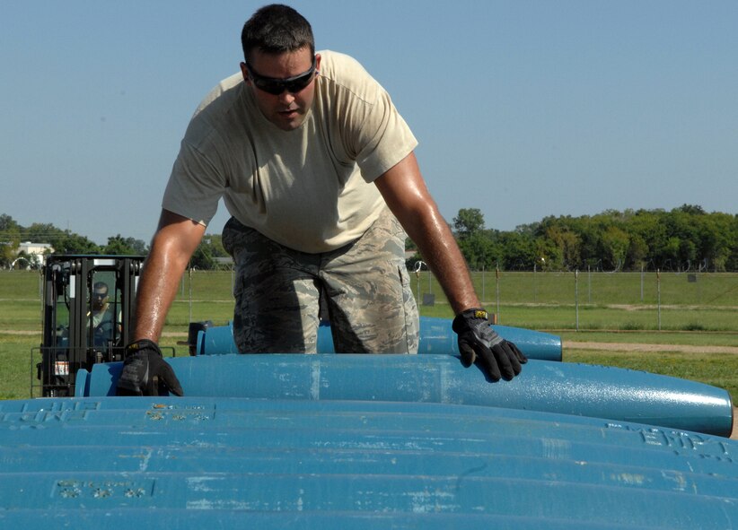Staff Sgt. Russell Fenimore, 2nd Munitions Squadron munitions maintenance team, rolls an inert Mark 82 low drag unguided bomb onto the trailer on Barksdale Air Force Base, La., Aug 20. The Mark 82 roll is part of the 2012 Global Strike Challenge where the 11-person munitions maintenance team will load 162 of the Mark 82s onto four tractor trailers in preparation for the GSC. (U.S. Air Force photo/Staff Sgt. Jason McCasland)(RELEASED)