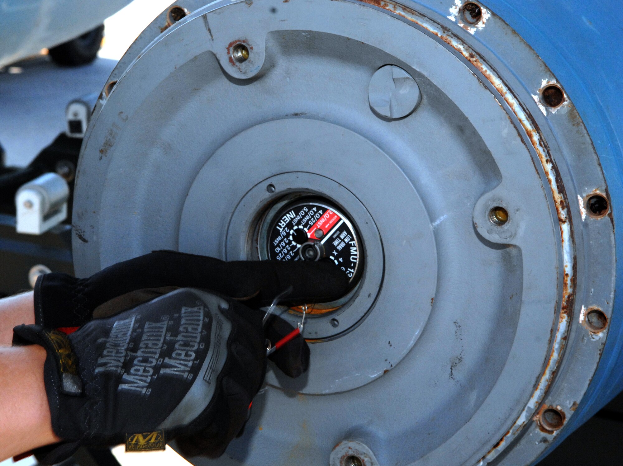 A safety pin is removed from an inert FMU-152 fuse installed on a GBU-31 version one bomb on Barksdale Air Force Base, La., Aug 20. The 11-person team will compete against other bases within the Air Force Global Strike Command to defend Barksdale's title of being the best munitions maintenance team in AFGSC. (U.S. Air Force photo/Staff Sgt. Jason McCasland)(RELEASED)