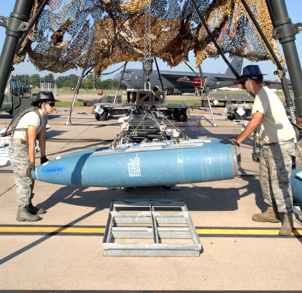 Senior Airmen Brittnay Arellano and Staff Sgt. Russell Fenimore, both from 2nd Munitions Squadron munitions maintenance team, load an inert two-thousand pound GPS guided GBU-31 version one bomb onto the track on Barksdale Air Force Base, La., Aug 20. The GBU-31 FMU-152 fuse, nose cone and tail get installed while on the track. The track provides a mobile workstation so the bombs can be built and transferred to a trailer.(U.S. Air Force photo/Staff Sgt. Jason McCasland)(RELEASED)
