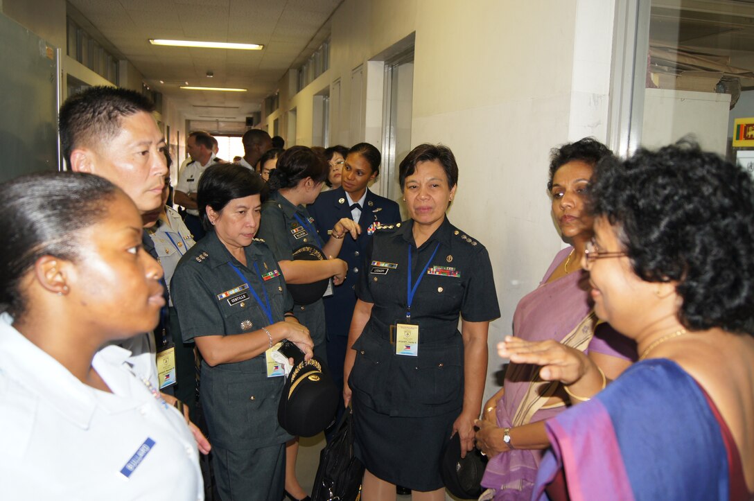Technical Sergeant Sharnta S. Bullard, Anderson Air Force Base, Guam, and Senior Master Sergeant Peter Chin, Kadena Air Base, Okinawa, join Colonel Bernadette P. Centillo of the Philippine Army, as they are briefed by the Directors of the Sri Lanka Medical Research Institute on its capabilities during the Asia Pacific Military Nursing Exchange August 10, in Colombo, Sri Lanka.   The APMNE provides a unique opportunity for U.S. military nursing leaders to engage with senior military nursing colleagues in the Asia-Pacific region on issues of mutual interest, such as infection control, military nursing practices, nursing roles in stability operations, disaster preparedness/response, aeromedical evacuation, international clinical research, evidence-based practice, nursing education and career development.  One hundred fifty three nursing professionals attended from the countries of Sri Lanka, the United States, Cambodia, China, Indonesia, Japan, Korea, Maldives, Malaysia, Nepal, Philippines, and Thailand.  (U.S. Air Force photo)