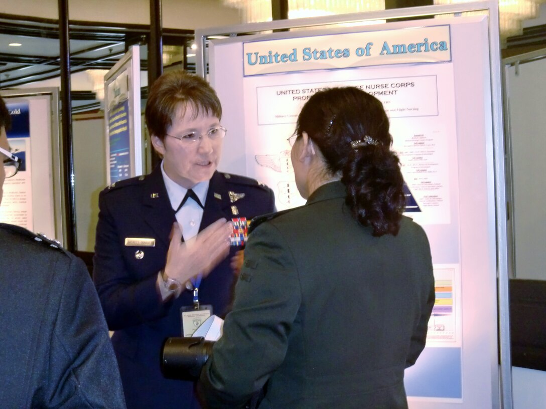 U.S. Air Force Colonel Tamara A. Averett-Brauer, Pacific Air Force command nurse, discusses a U.S. Air Force Nurse Corps career path presentation with Senior Colonel Yan-Lan Ma, a nursing representative from the Peoples Republic of China, during the Asia Pacific Military Nursing Exchange August 10, in Colombo, Sri Lanka.   The APMNE establishes an environment where Asia Pacific regional nursing leaders are able to develop and mature in order to build a regional network of shared expertise.  It advances the professionalism of nursing by highlighting the role of nursing personnel in health care in the region and elevating the stature of military nurses as force multipliers.  (U.S. Air Force photo)