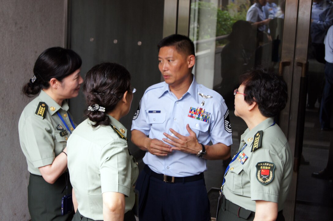 U.S. Air Force Senior Master Sergeant Peter Chin, 18th Aeromedical Evacuation Squadron, Kadena Air Base, Okinawa, speaks with (from right to left) Senior Colonel Xiaoli Tian, head delegate, Senior Colonel Yan-Lan Ma, and Senior Colonel Zhang Ling-Juan, Peoples Republic of China delegates from the Nursing Department, Changhai Hospital, Second Military University, Shanghai, China, during the Asia Pacific Military Nursing Exchange August 10, in Colombo, Sri Lanka.  The APMNE provides a unique opportunity for U.S. military nursing leaders to engage with senior military nursing colleagues in the Asia-Pacific region on issues of mutual interest, such as infection control, military nursing practices, nursing roles in stability operations, disaster preparedness/response, aeromedical evacuation, international clinical research, evidence-based practice, nursing education and career development. (U.S. Air Force photo)  