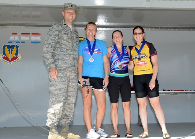 Lt. Col. Stephen Hoffman, 9th Mission Support Group deputy commander, poses with one of the winning relay teams after the Recce Challenge Sprint Triathlon August 23, 2012 at Beale Air Force Base, Calif. Competitors could complete the three leg course alone or work as a team to finish the race. (U.S. Air Force photo by Senior Airman Shawn Nickel/Released)