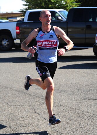 Master Sgt. Alex Roberson, 713th Combat Operations Squadron logistics planner, sprints to the finish during the last leg of the Recce Challenge Sprint Triathlon August 23, 2012 at Beale Air Force Base, Calif. Roberson finished in less than 53 minutes placing first in his age group and faster than any other participant. (U.S. Air Force photo by Senior Airman Shawn Nickel/Released)