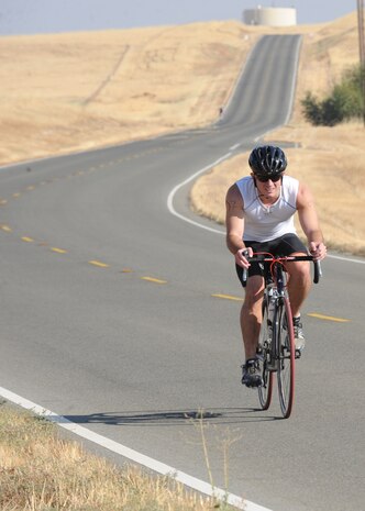 An Airman descends a hill from the 7th Space Warning Squadron during the Recce Challenge Sprint Triathlon August 23, 2012 at Beale Air Force Base, Calif. Participants could choose between a road ride up sharp inclines or to tackle the dirt course which was equally as steep. (U.S. Air Force photo by Mr. John Schwab/Released)