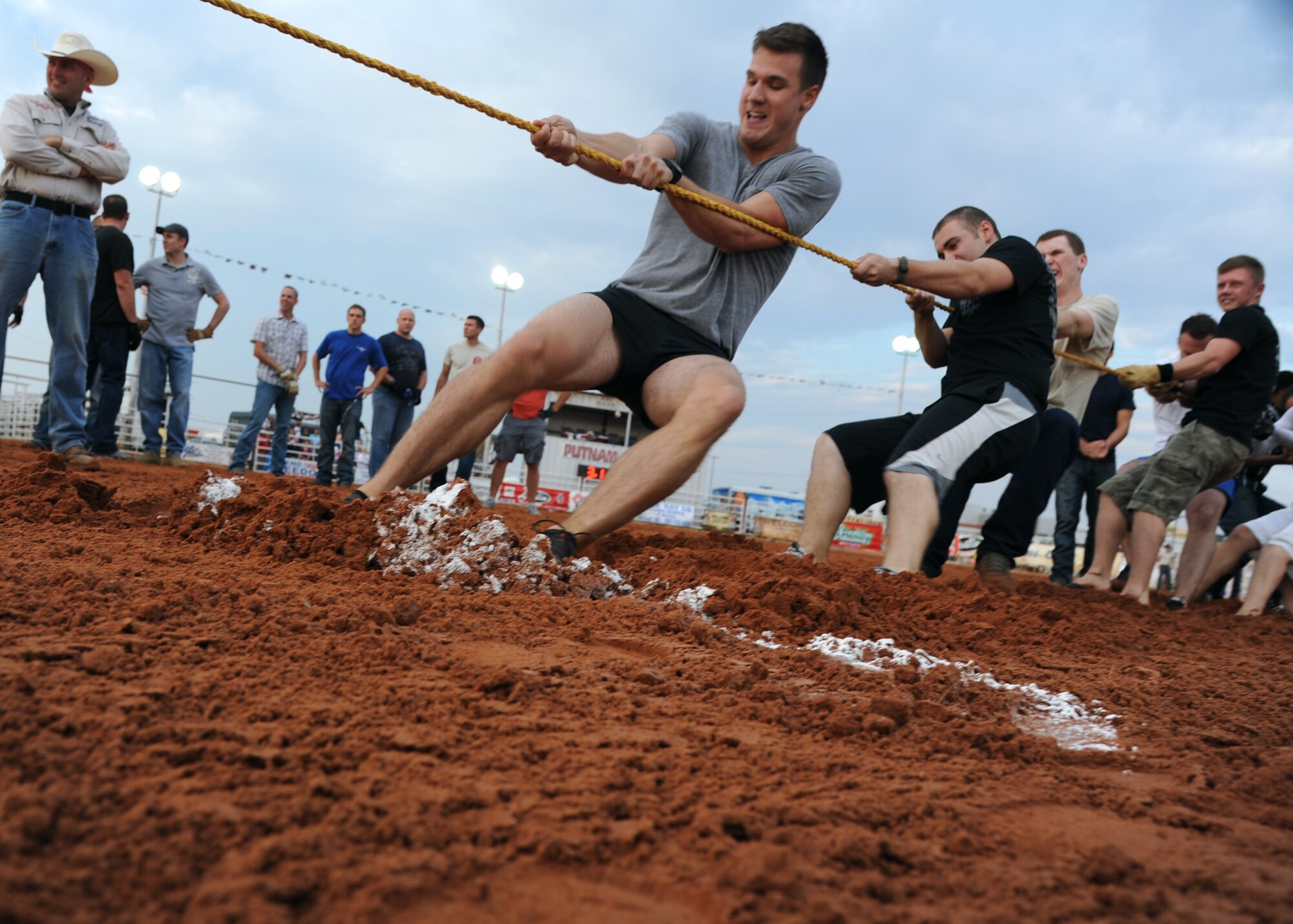 ALTUS AIR FORCE BASE, Okla. – Members of the 97th Training Squadron compete in a tug of war competition during Military Appreciation Night at the Great Plains Stampede Rodeo grounds, Aug. 23, 2012. The tug of war competition was one of the events during Military Appreciation Night where the 97th Security Forces Squadron defeated the 97th TRS and 58th Airlift Squadron teams. (U.S. Air Force photo by Airman 1st Class Klynne Pearl Serrano / 97th Air Mobility Wing / Released)
