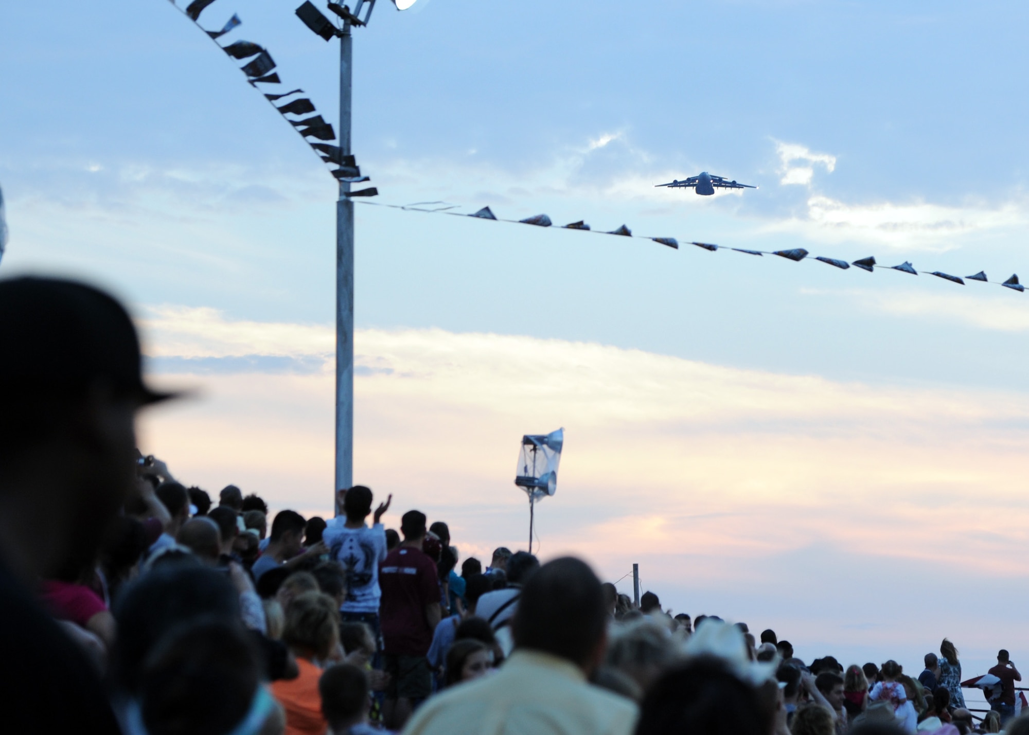 ALTUS AIR FORCE BASE, Okla. – Guests of the Great Plains Stampede Rodeo watch a C-17 Globemaster III fly over the Great Plains Stampede Rodeo grounds during Military Appreciation Night, Aug. 23, 2012. Military Appreciation Night is one event held during the Great Plains Stampede Rodeo in Altus. (U.S. Air Force photo by Airman 1st Class Klynne Pearl Serrano / 97th Air Mobility Wing / Released) 