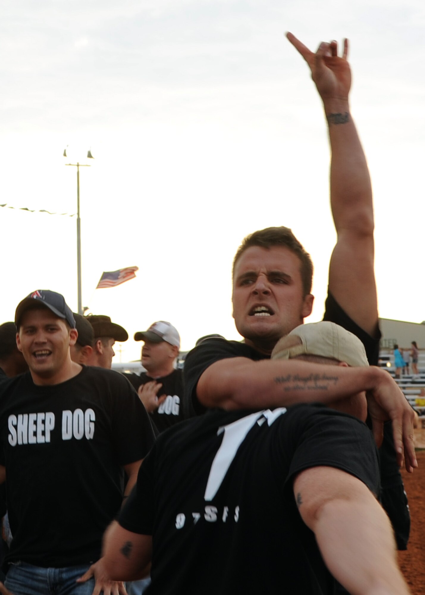 ALTUS AIR FORCE BASE, Okla. – Senior Airman Joshua Sams, 97th Security Forces Squadron unit trainer, jumps in celebration after winning the tug of war competition during Military Appreciation Night at the Great Plains Stampede Rodeo grounds, Aug. 23, 2012. Military Appreciation Night is one event held during the Great Plains Stampede Rodeo in Altus. (U.S. Air Force photo by Airman 1st Class Klynne Pearl Serrano / 97th Air Mobility Wing / Released)