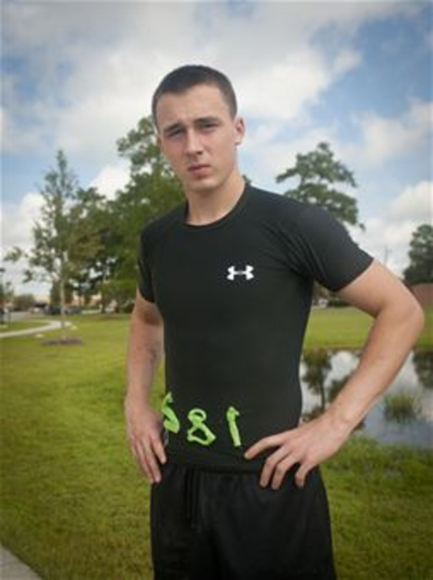 Airman 1st Class Adam Orton,  poses for a photo in the shirt he wore during the 2012 Spartan Death Race, Aug. 9, 2012 at Moody Air Force Base, Ga. One of the first challenges of the race was to sew their number on a shirt in 3-inch block numbers. 74th Aircraft Maintenance Unit aerospace propulsion journeyman. (U.S. Air Force photo/Airman 1st Class Jarrod Grammel)