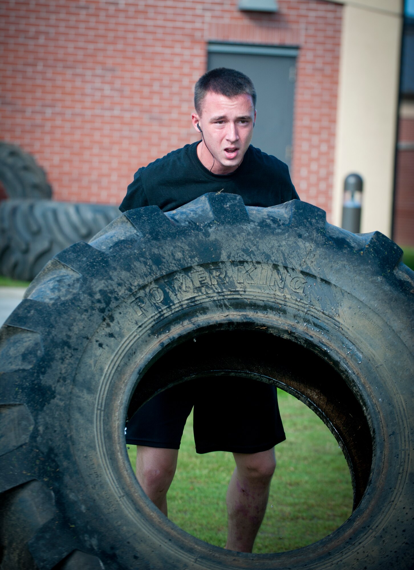 Airman 1st Class Adam Orton flips a tire during a workout at Moody Air Force Base, Ga., Aug. 9, 2012. Orton participated in the 2012 Spartan Death Race, which is held annually in Pittsfield, Vt. He plans to compete again next year. Orton is a 74th Aircraft Maintenance Unit aerospace propulsion journeyman. (U.S. Air Force photo/Airman 1st Class Jarrod Grammel)