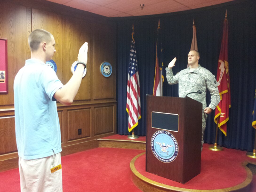 Christopher Lester (left) takes the oath of enlistment given to him by 1st Lt. Barrett Foster in Raleigh in early August. Christopher is the son of 916th Security Forces First Sergeant William Lester. (USAF photo by MSgt. Hazel Finley, 916RS)