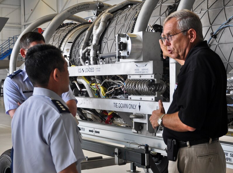 Stanley Stevens, a Pratt and Whitney employee, briefs General Shigeru Iwasaki, air self-defense force, chief of staff, joint staff, Japan Self-Defense Forces, on the F-135 engine for the joint strike fighter during the general's visit to the 33rd Fighter Wing Aug. 20.  Iwasaki's visit to Eglin was included in a larger tour of five Air Force and Department of the Navy installations as part of a Chairman of the Joint Chiefs of Staff counterpart visit. The Japan Ministry of Defense announced its selection of the F-35 Lightning II as the Japan Air Self Defense Force's next generation fighter aircraft December 2011 and signed a foreign military sales agreement in June. The F-35 is the world's only "fifth generation" multi-role fighter jet, combining state-of-the art stealth technology with highly advanced avionics and maneuverability. The fighter is being developed jointly with the U.S. Air Force, Navy and Marine Corps along with support from the United Kingdom, Italy, The Netherlands, Turkey, Canada, Australia, Denmark and Norway.  (U.S. Air Force photo/Maj. Karen Roganov)

