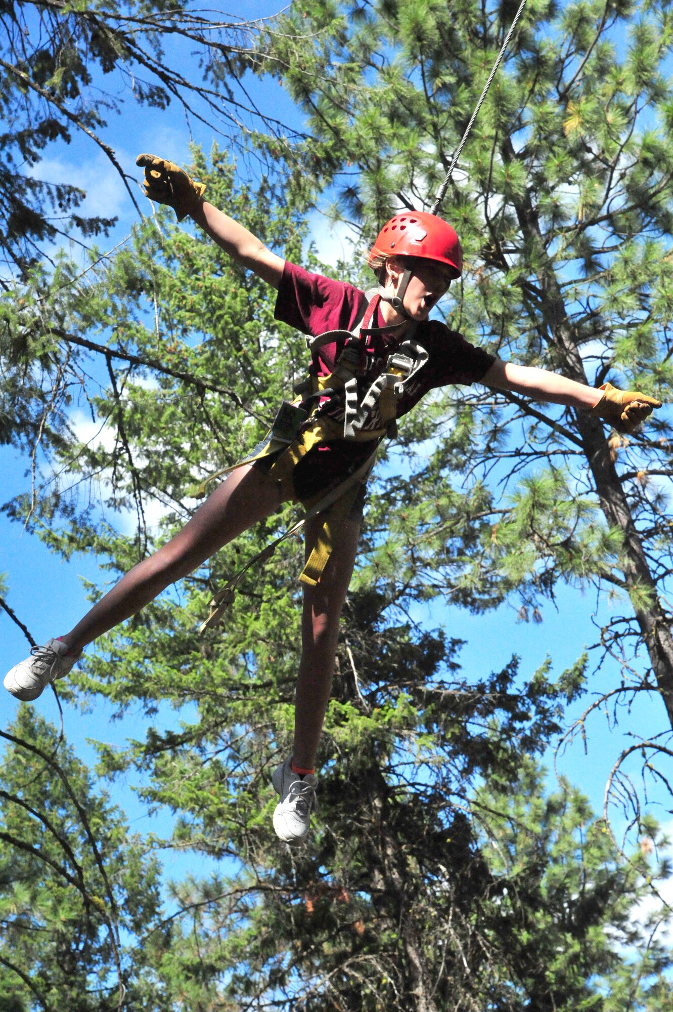 Shelby, a member of the D.A.R.E. summer camp, screams and spreads her arms out in the air while on the zip-line swing Aug. 22, 2012 at Adventure Dynamics in Nine Mile Falls, Washington. (U.S. Air Force photo by Airman 1st Class Earlandez Young)