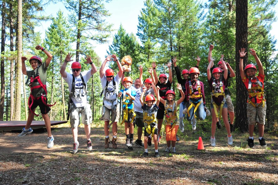 After getting strapped in their harness, members of the D.A.R.E. summer camp jump in the air before making their way to the zip-line swing Aug. 22, 2012 at Adventure Dynamics in Nine Mile Falls, Washington. Each year, Fairchild's D.A.R.E. officer hosts a summer day camp for elementary-aged students about to enter the sixth grade. (U.S. Air Force photo by Airman 1st Class Earlandez Young)