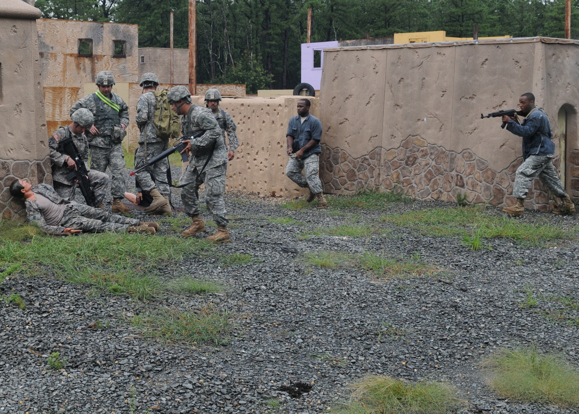 Two Soldiers role-playing as villager-insurgents ambush Liberty Warrior Soldiers of the 77th Sustainment Brigade in a mock Afghan village Aug. 14. The training was part of the brigade’s Operation Sustainment Warrior exercise Aug. 5 to Aug. 19 at Joint Base McGuire-Dix-Lakehurst, N.J. (U.S. Army photo by Staff Sgt. Neil W. McCabe/Released)