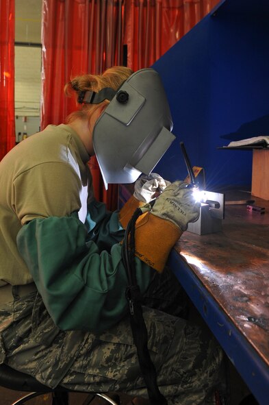 Airman 1st Class Alison Kriener, 2nd Maintenance Squadron metals technology, welds a tie-down bracket on Barksdale Air Force Base, La., Aug. 24. Metals technology Airmen fabricate parts for aircraft, munitions and equipment, and are capable of building items from scratch. (U.S. Air Force photo/Airman 1st Class Micaiah Anthony)(RELEASED)