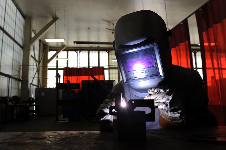 Airman 1st Class Alison Kriener, 2nd Maintenance Squadron metals technology, welds a tie-down bracket on Barksdale Air Force Base, La., Aug. 24. Airmen must wear proper protective equipment such as gloves and welding helmets while welding to prevent injuries. (U.S. Air Force photo/Airman 1st Class Micaiah Anthony)(RELEASED)
