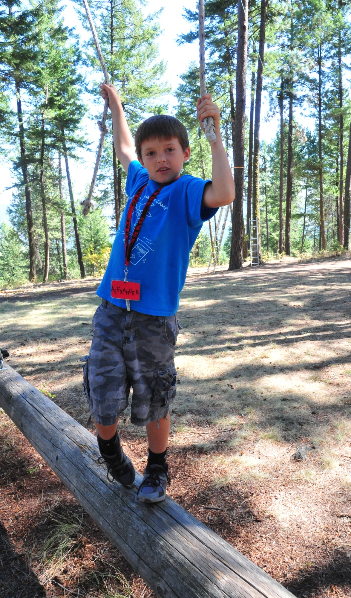 Alexander, a member of the D.A.R.E. summer camp, walks along the final log finishing up the tight rope team challenge Aug. 22, 2012 at Adventure Dynamics in Nine Mile Falls, Washington. Alexander said his favorite activity was the zip-line swing. (U.S. Air Force photo by Airman 1st Class Earlandez Young) 