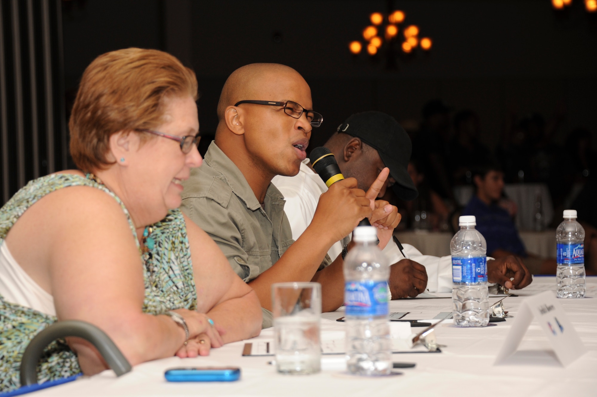 1st Lt. Mike Washington, 87th Force Support Squadron services flight originally from Fayetteville, N.C. (center), Sgt. 1st Class Eric Turner, Joint Readiness Center noncommissioned officer and AMC Icon local winner last year originally from South Philadelphia (right), and Ardith Bowers, a retired entertainment specialist with the Army's Morale, Welfare and Recreation originally from Lake County, Ill. (left), judge contestants during AMC Icon competition held at Tommy B's Community Activities Center Aug. 16. The judges also provided scored and provided input to participants during the Army's Operation Rising Star singing competition. (U.S. Air Force photo by 2nd Lt. David J. Murphy/released)