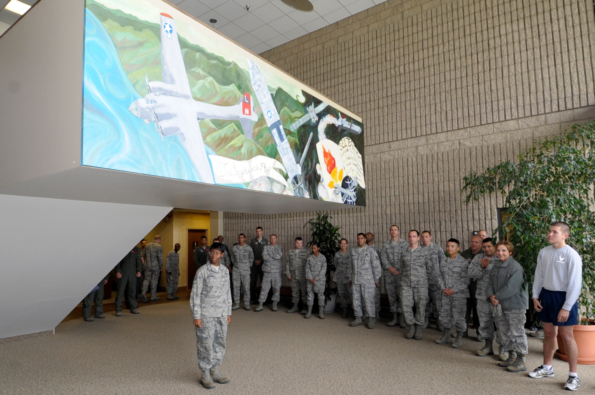 VANDENBERG AIR FORCE BASE, Calif. -- Airman 1st Class Eboni Alexander of the 381st Training Support Squadron is recognized for her contributions toward a mural representing the heritage of the 381st Training Group during the mural unveiling ceremony here, August 23, 2012. Alexander designed the mural and led the team depicting the three main eras of the unit; the 381st Bombardment Group, the 381st Strategic Missile Wing, and the 381st Training Group. (U.S. Air Force photo/Jerry E. Clemens Jr.)