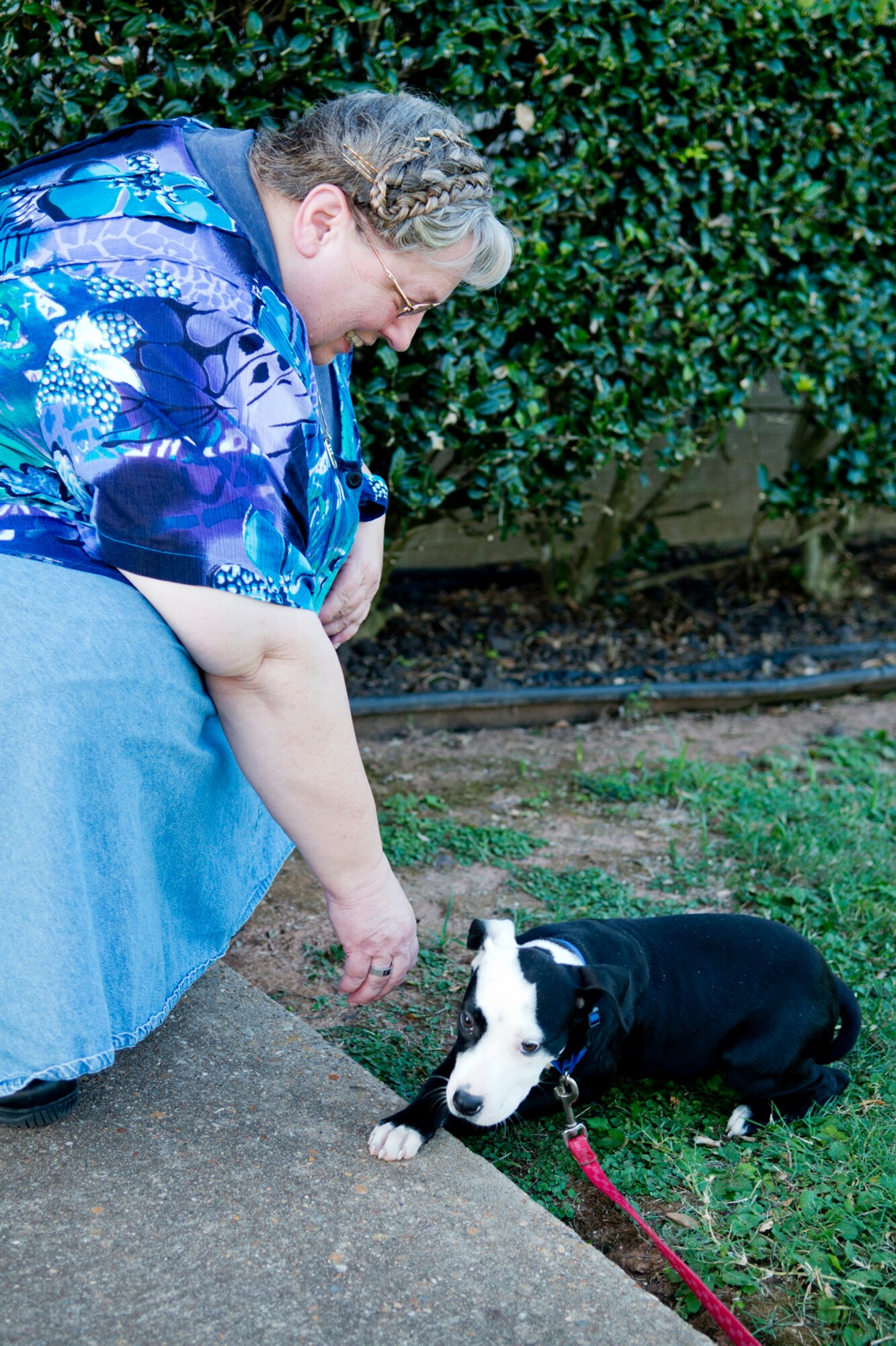 Beverly Johnson, a member of the 307th Bomb Wing, meets her new companion, Lilly, on Aug. 24, 2012, Barksdale Air Force Base, La. Several months ago, Johnson's dog Little Bear died after they were together for 13 years, but now she has Lilly to help mend her broken heart. (U.S. Air Force photo by Master Sgt. Greg Steele/Released)
