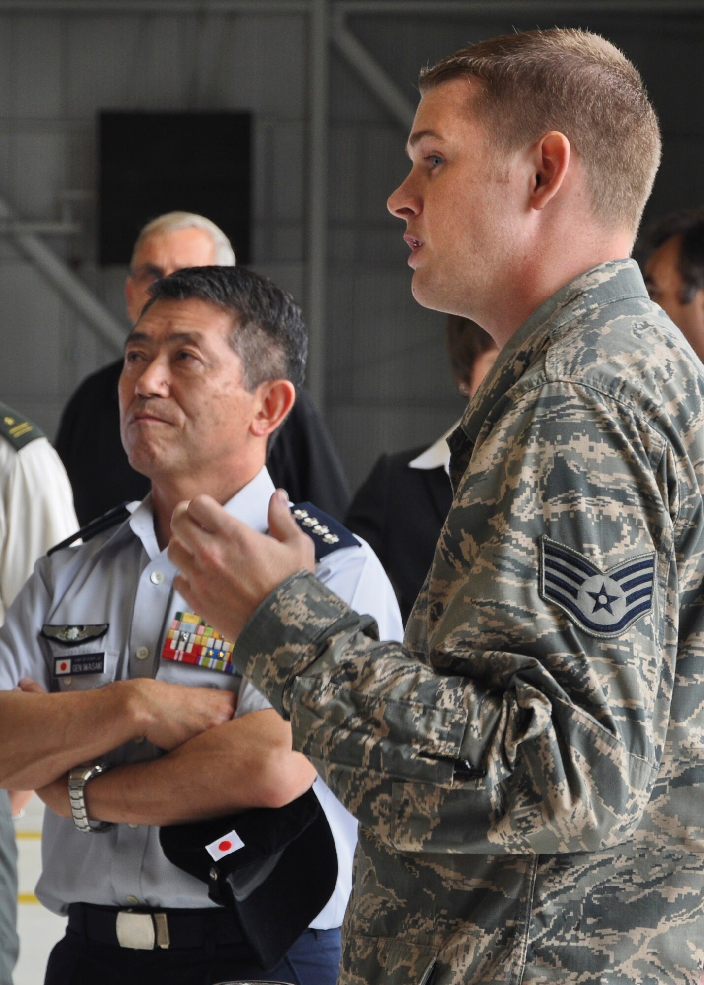 Staff Sgt. Skyler DeBoer, a crew chief with the 58th aircraft maintenance unit, briefs General Shigeru Iwasak, the air self-defense force, chief of staff, joint staff, Japan Self-Defense Forces on F-35 Lightning II maintenance and training during  the general's visit to the 33rd Fighter Wing Aug. 20. Iwasaki's visit to Eglin was included in a larger tour of five Air Force and Department of the Navy installations as part of a Chairman of the Joint Chiefs of Staff counterpart visit. The Japan Ministry of Defense announced its selection of the F-35 Lightning II as the Japan Air Self Defense Force's next generation fighter aircraft December 2011 and signed a foreign military sales agreement in June. The F-35 is the world's only "fifth generation" multi-role fighter jet, combining state-of-the art stealth technology with highly advanced avionics and maneuverability. The fighter is being developed jointly with the U.S. Air Force, Navy and Marine Corps along with support from the United Kingdom, Italy, The Netherlands, Turkey, Canada, Australia, Denmark and Norway. (U.S. Air Force photo/Karen Roganov) 
