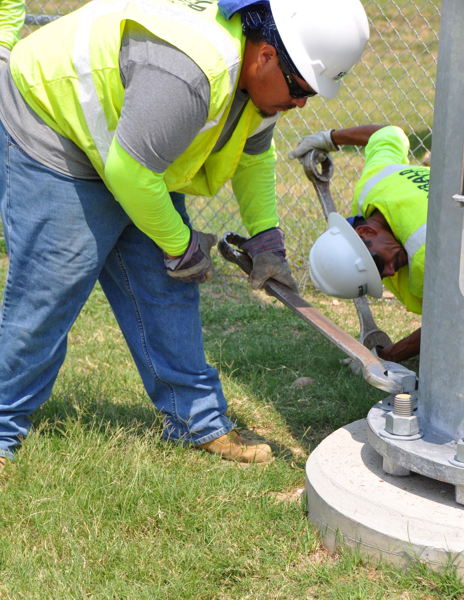 Emerald Standard Inc. crewmembers work to secure one of the new light poles installed on the flightline of the 433rd Airlift Wing at Joint Base San Antonio-Lackland, Texas on August 23, 2012. (U.S. Air Force photo/Senior Airman Viola M. Hernandez) 