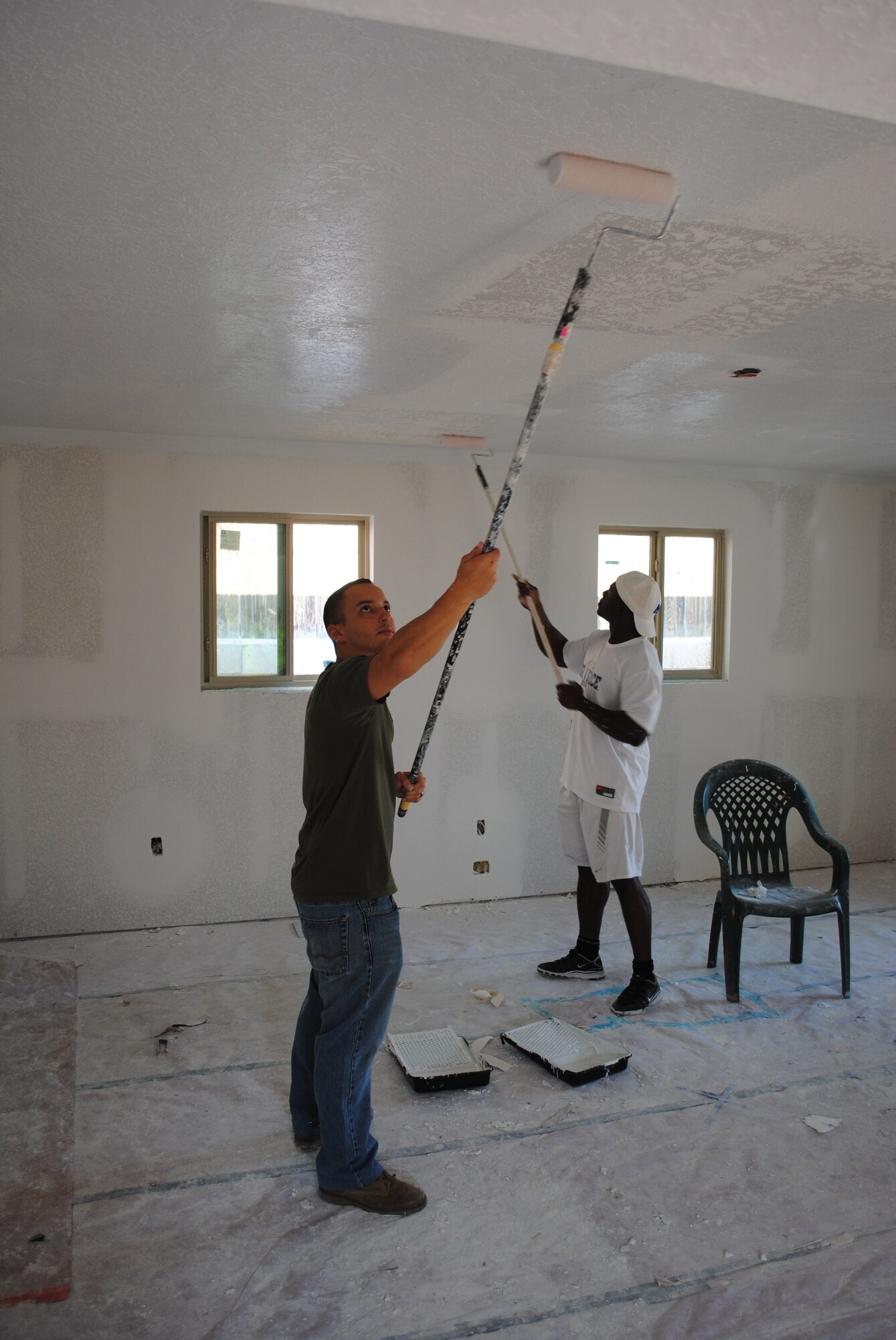 KIRTLAND AFB, N.M. -- Cassie Macdonald and 1st Lt. Joe Castillo, Air Force Nuclear Weapons Center, along with 16 other Airmen, primed and painted a house and garage Saturday for Habitat for Humanity. (Photo by Mike Scott)