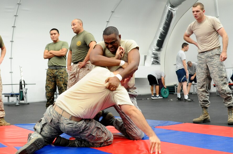 Staff Sgt. Erik Walker, 56th Medical Support Squadron, and Staff Sgt. Ronnie Saldana, 607th Air Control Squadron, grapple during the Marine Corps Martial Arts program green belt course August 21, 2012 held at the Combat Physical Training Center at Luke Air Force Base, Ariz. (U.S. Air Force photo by Senior Airman Sandra Welch) 