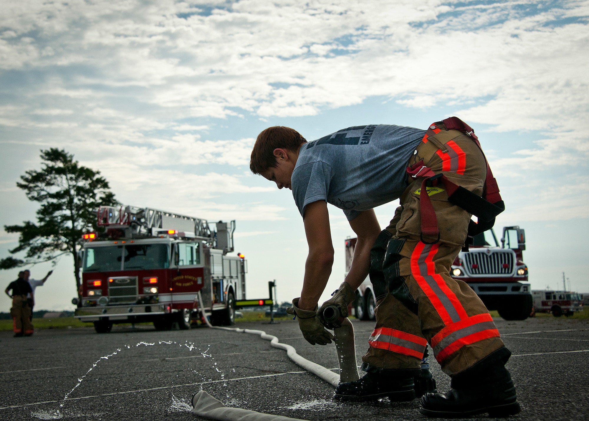 Amber Turek, of the 96th Test Wing fire department, disconnects hoses after successfully extinguishing a simulated truck fire during a Nuclear Accident Response Exercise at Eglin Air Force Base, Fla., Aug. 22.  Eglin agencies, including first responders, were evaluated on their reactions and responses to a vehicle explosion carrying nuclear material.  (U.S. Air Force photo/Samuel King Jr.)