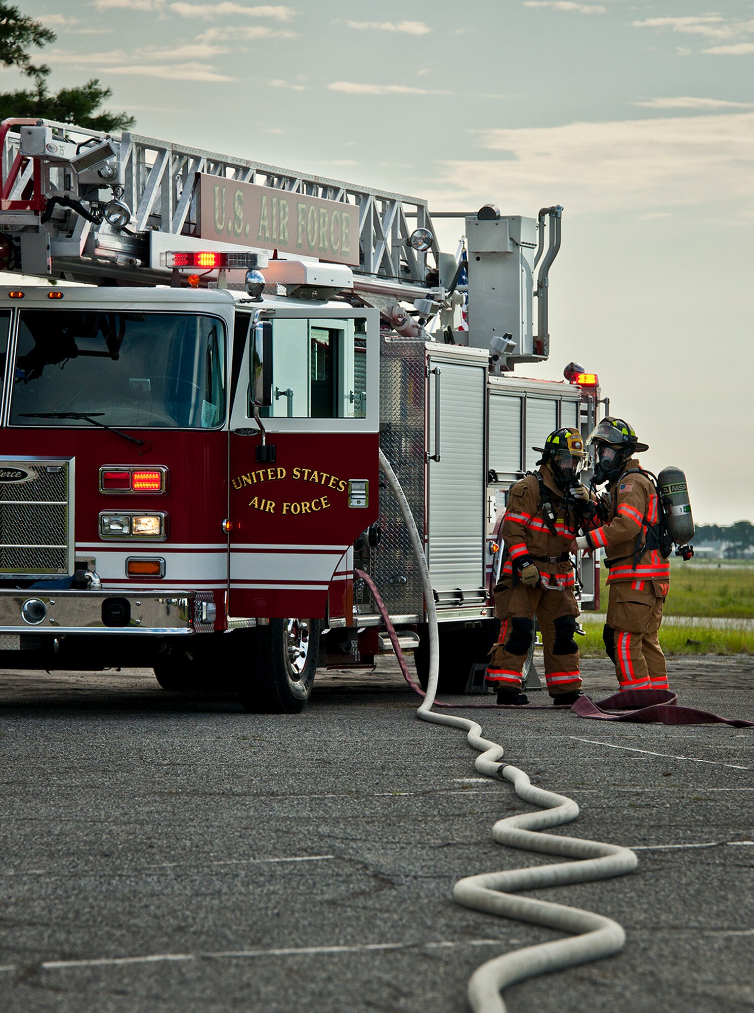 96th Test Wing firefighters discuss the next step after successfully putting out a simulated truck fire during a Nuclear Accident Response Exercise at Eglin Air Force Base, Fla., Aug. 22.  Eglin agencies, including first responders, were evaluated on their reactions and responses to a vehicle explosion carrying nuclear material.  (U.S. Air Force photo/Samuel King Jr.)