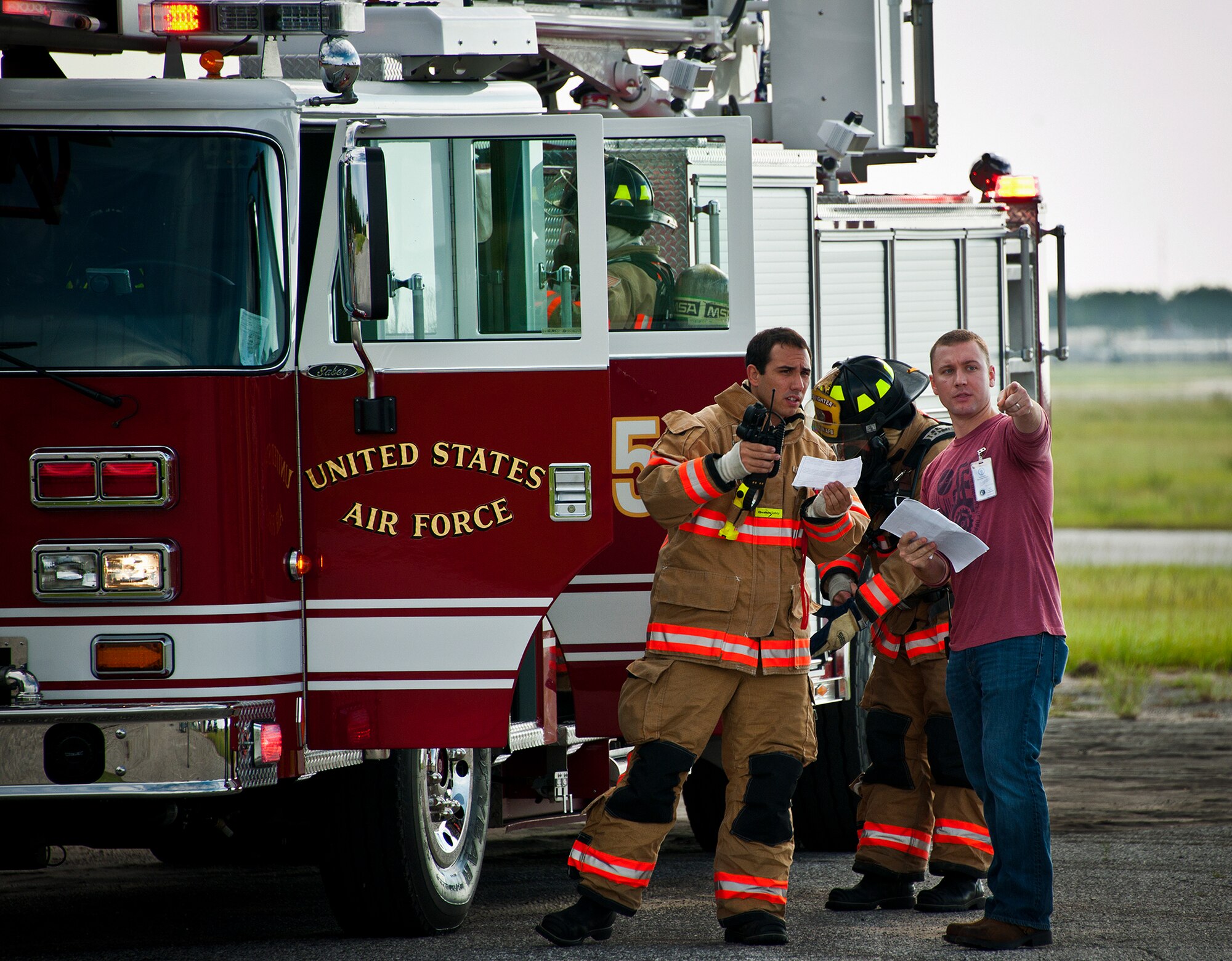 A witness recounts the scenario for the a member of the Eglin fire department during a Nuclear Accident Response Exercise at Eglin Air Force Base, Fla., Aug. 22.  Eglin agencies, including first responders, were evaluated on their reactions and responses to a vehicle explosion carrying nuclear material.  (U.S. Air Force photo/Samuel King Jr.)